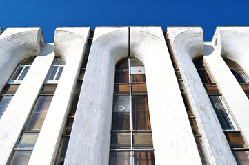 High building of futuristic design made of concrete - architecture modern background. Perspective bottom view, architecture cityscape