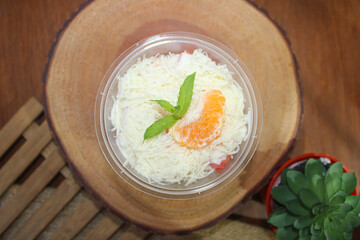 Healthy Creamy Fruit Salad with Grated Cheese and Mandarin Orange Garnish