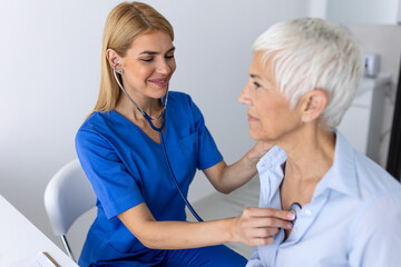 Fototapeta premium Close Up of Female Doctor Using Stethoscope on Senior Patient, Professional Medical Healthcare Auscultation for Elderly Woman, Clinical Diagnostic Screening and Preventive Patient Care in Clinic.