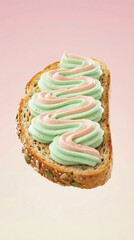 Multi Grain Bread Slice With Pink And Green Cream Spread