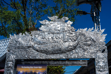 Separate fragments of a decorated Buddhist temple in Thailand on a sunny day