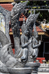 Separate fragments of a decorated Buddhist temple in Thailand on a sunny day