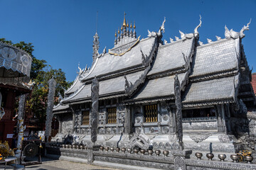 Separate fragments of a decorated Buddhist temple in Thailand on a sunny day