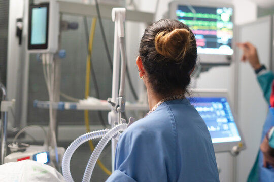 Healthcare provider monitoring patient vital signs in critical care