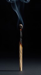 Half burned matchstick isolated on dark background burnout energy concept