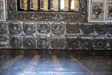 Separate fragments of a decorated Buddhist temple in Thailand on a sunny day