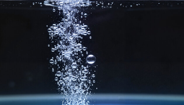 A dense wall of small bubbles against the black background of an aquarium