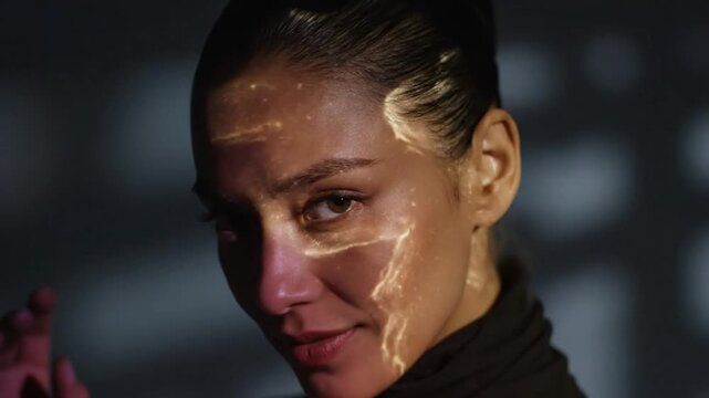 Mesmerizing woman with projection mapping light illuminating her face in a captivating artistic display