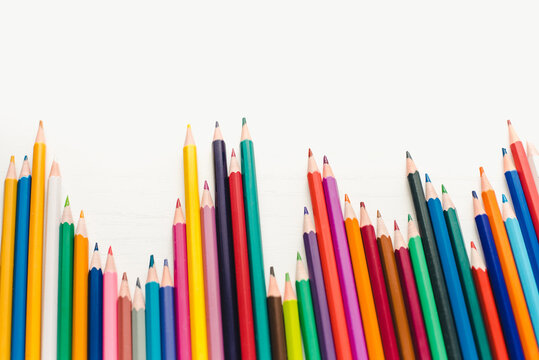 Colored pencils on a white background. Background of multicolored pencils.