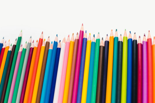 Colored pencils on a white background. Background of multicolored pencils.