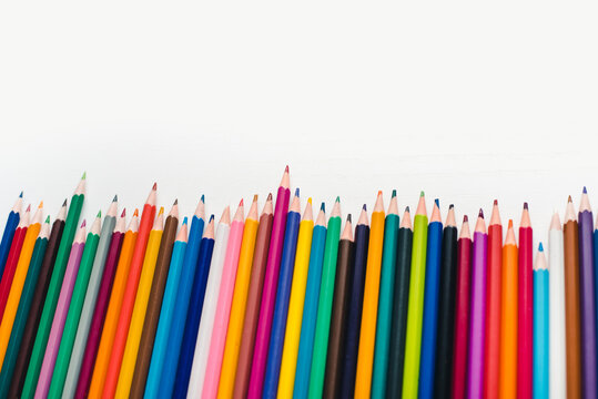 Colored pencils on a white background. Background of multicolored pencils.