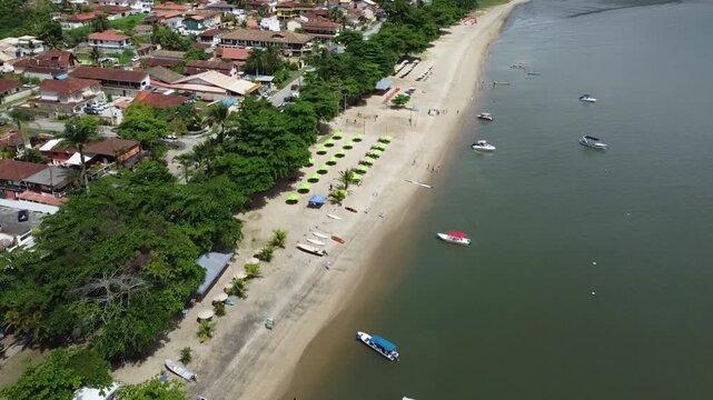 Aerial view of Jabaquara Beach near Paraty, Brazil, showing tropical coastline, calm waters, and surrounding nature. Scenic drone footage capturing the relaxed atmosphere of this popular destination