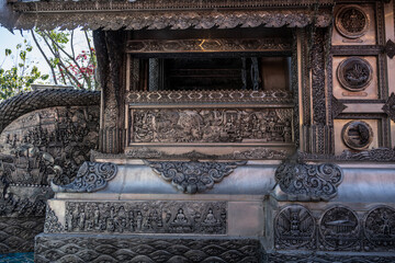Separate fragments of a decorated Buddhist temple in Thailand on a sunny day