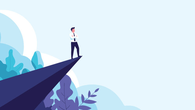 Courageous businessman standing on the edge of a high mountain cliff looking out into the distance towards future opportunities.