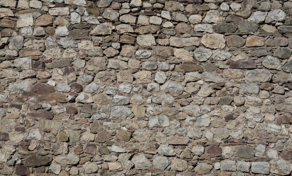 gray gray beige brick rocks stone paved floor flooring texture design as pattern backdrop Seamless wall background with natural sandstone tiles stitched together with clay Top front view Nis fortress