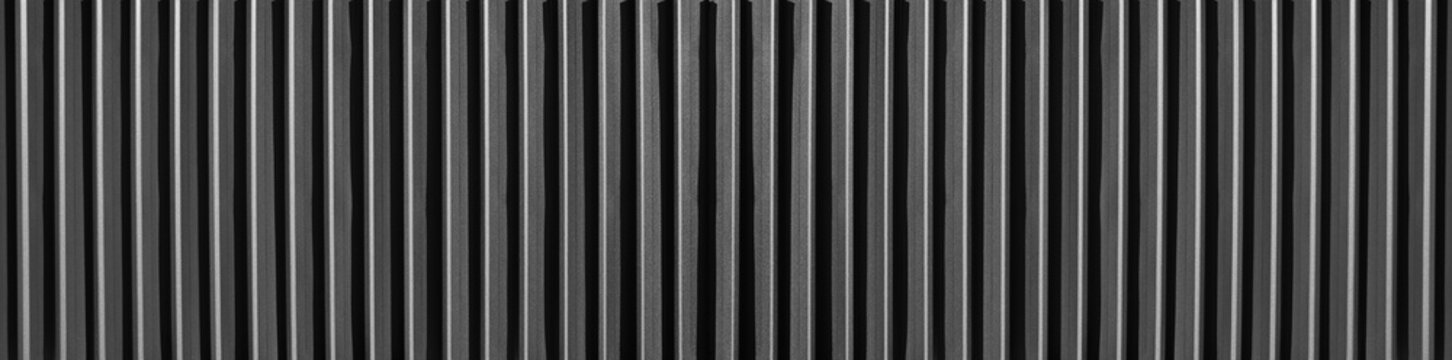 Black Corrugated metal texture surface or galvanized steel. ribbed painted metal fence panelling background Black corrugated metal texture, dark abstract backdrop