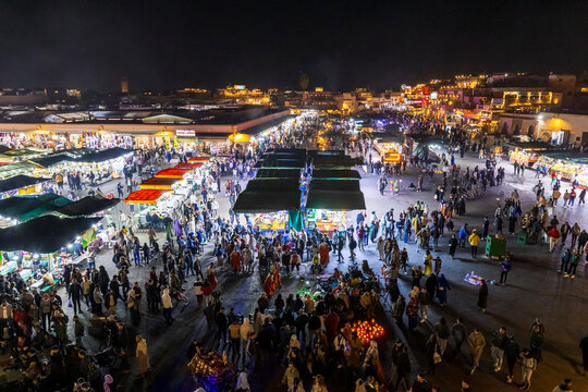 Night aerial view of a crowded marketplace, the iconic and famous Jamaa el Fna square,  with food stalls and people. Jamaa el Fna,Marrakech,Unesco hertage,Morocco