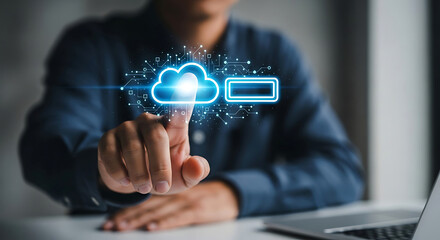 Naklejka premium Man interacting with cloud data storage icon in blue glow with soft focus and shallow depth of field for technology