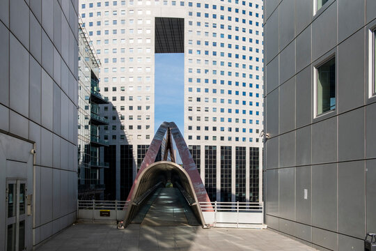 Modern sculpture landmark in corporate urban La Defense Paris plaza with empty space and contemporary architecture background in daylight