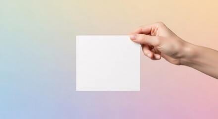 Obraz premium A horizontal blank white card mockup held by a hand against a soothing mint green and lavender purple gradient background with soft studio lighting.