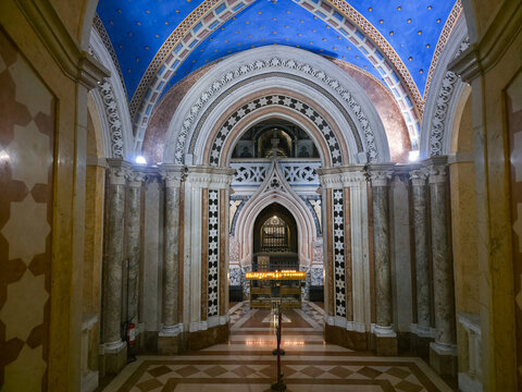 Perspective view of the neo-Gothic crypt in the Basilica of Saint Clare in Assisi, featuring marble columns, a starry blue ceiling and the sacred shrine, UNESCO site, Umbria, Italy