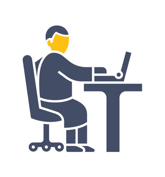 Man is sitting on the chair and working his laptop which is on the table