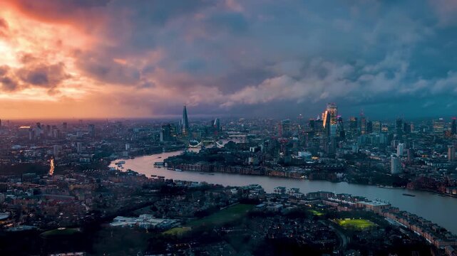 Elevated time lapse view of the cityscape of London, UK, with dramatic cloudscape, sunshine and rainfall during sunset time
