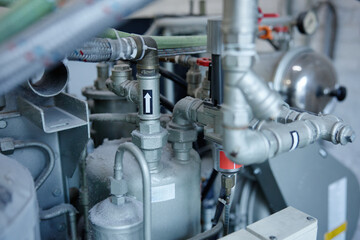 A detailed close up of a compressor machine featuring two gauges situated on it