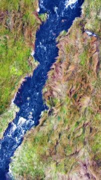 Top down aerial view of fast flowing river in North Wales. Ideal for travel vlogs and nature-themed Reels. Vertical video 9:16 format.