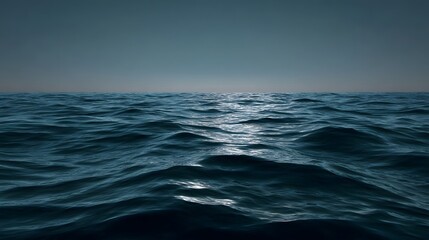 Fototapeta premium A dark vast ocean horizon under a moody twilight sky with gentle waves and subtle reflections