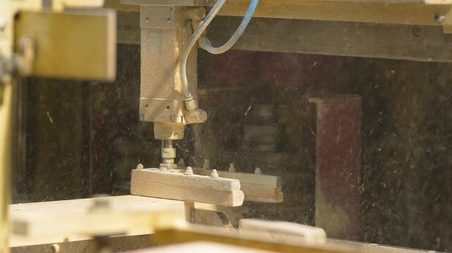 Close up of an automated industrial machine processing wood planks in a sawmill. Perfect for industrial manufacturing, timber production, and woodworking technology content.