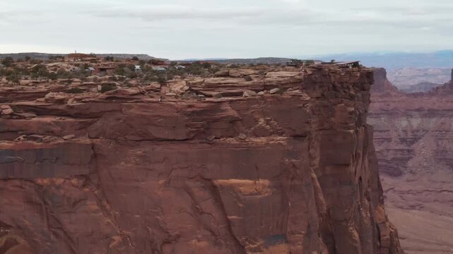 A drone view panning along a sheer cliff at Dead Horse State Park, Utah.