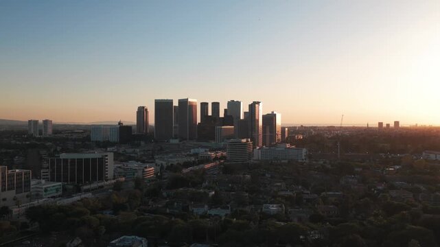 Wide aerial panning shot of Century City during sunset in Los Angeles, California. 4K