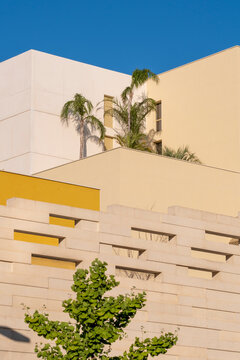Modern residential architecture facade with palms in Port Marianne Montpellier France under summer blue sky creating bright coastal city mood