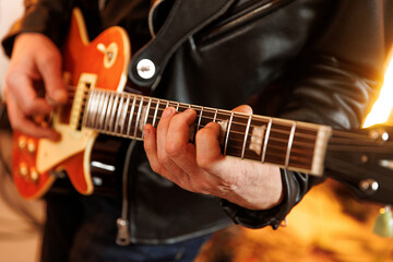 Obraz premium Guitarist fretting chords on electric guitar in studio