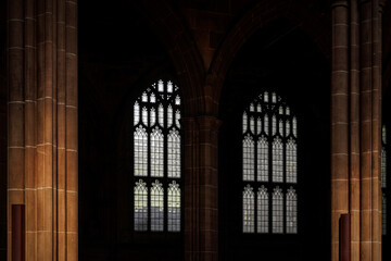 Obraz premium Gothic church windows and stone pillars in low light