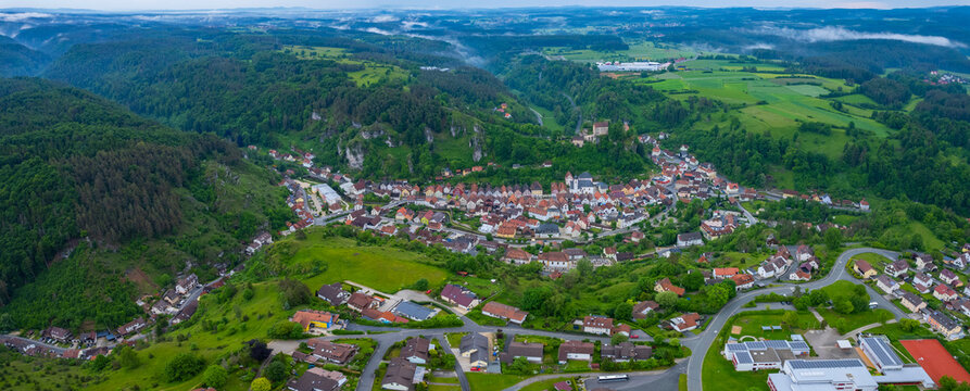 A panoramic aerial view from the old town of the city pottenstein  in Germany. On a cloudy morning in spring.
