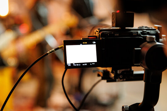 Video camera recording live music performance indoors