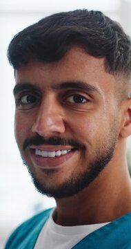 Man, doctor and face with smile at clinic for career with pride, confidence and medical services. Person, surgeon and healthcare professional in portrait, happy and job at hospital in Colombia