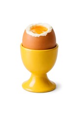 A soft-boiled egg rests in a yellow cup. The egg has a bit of its top removed, showing the golden yolk inside. The scene is bright with gentle light