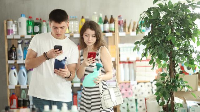 European spouses customer scans qr code on chemical cleaner spray label. Customer follows link and reads information about product, data on recycling of packaging
