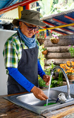 A farm man washing his hands