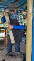 A farm man shoveling corn
