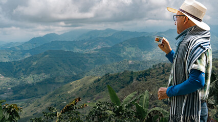 man on mountain drinking coffee