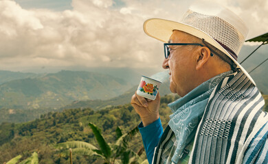 Man in a field with drink coffee