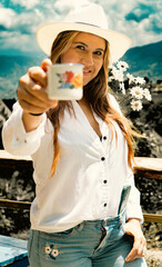 young woman in farmer drinking coffee