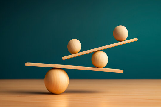 Conceptual balance with wooden spheres and planks arranged in equilibrium on wooden surface, symbolizing physics principles of torque, center of mass, stability, and mechanical balance