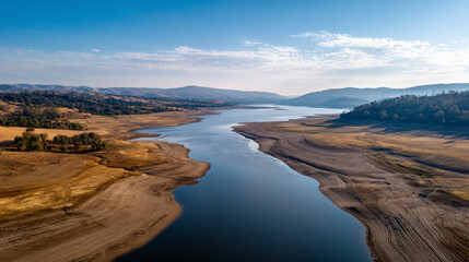 Aerial drone view of massive dry reservoir bed. Water crisis and water shortage in summer during long drought is a global problem of drought on the planet.
