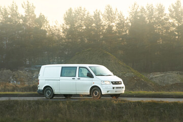 Fototapeta premium Logistics van driving in outdoor setting