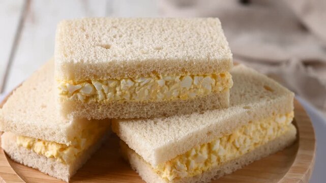 Tamago Sando sandwich on wooden table. Traditional japanese sandwich
